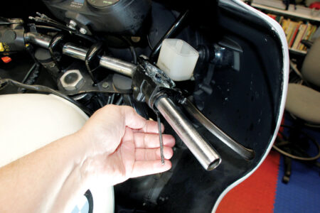 A hand holding a 4mm hex key